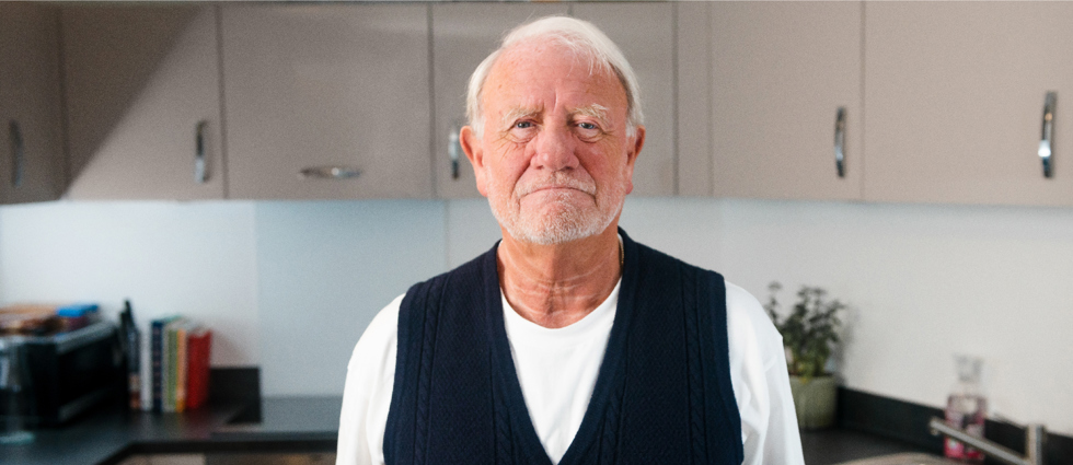 man in cardigan with white t shirt